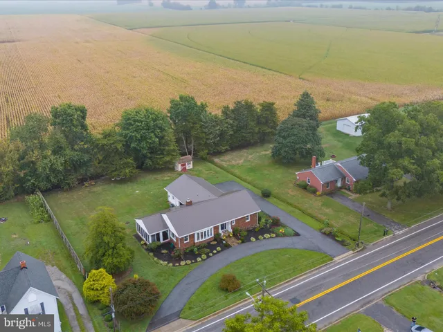 an aerial view of a house with a garden and yard