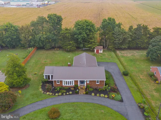 an aerial view of residential house with outdoor space and parking