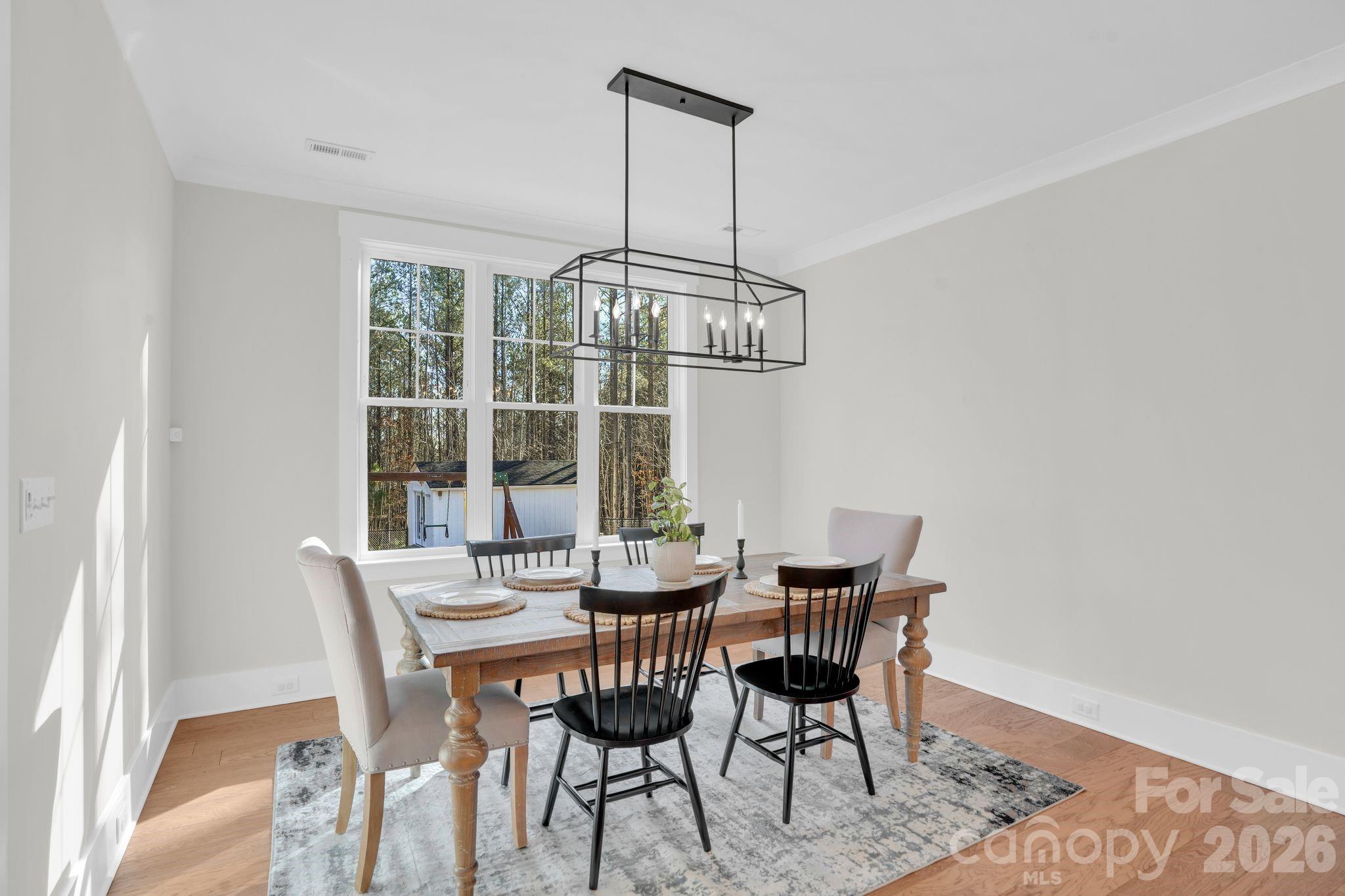 3134 Ranger Road Clover, SC 29710 - Photo 13 of 29 a dining room with furniture a chandelier and wooden floor