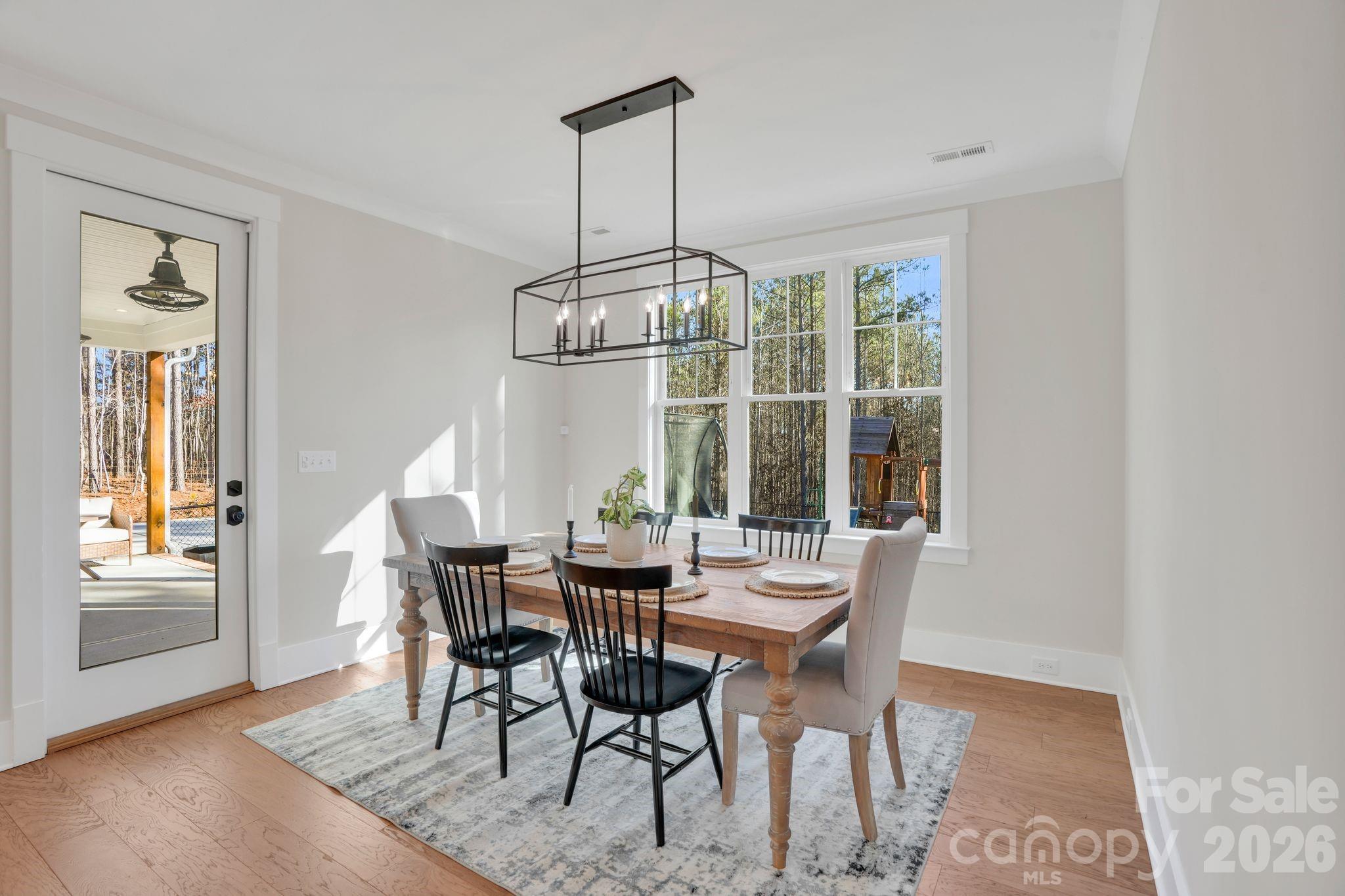 3134 Ranger Road Clover, SC 29710 - Photo 14 of 29 a dining room with furniture a chandelier and wooden floor