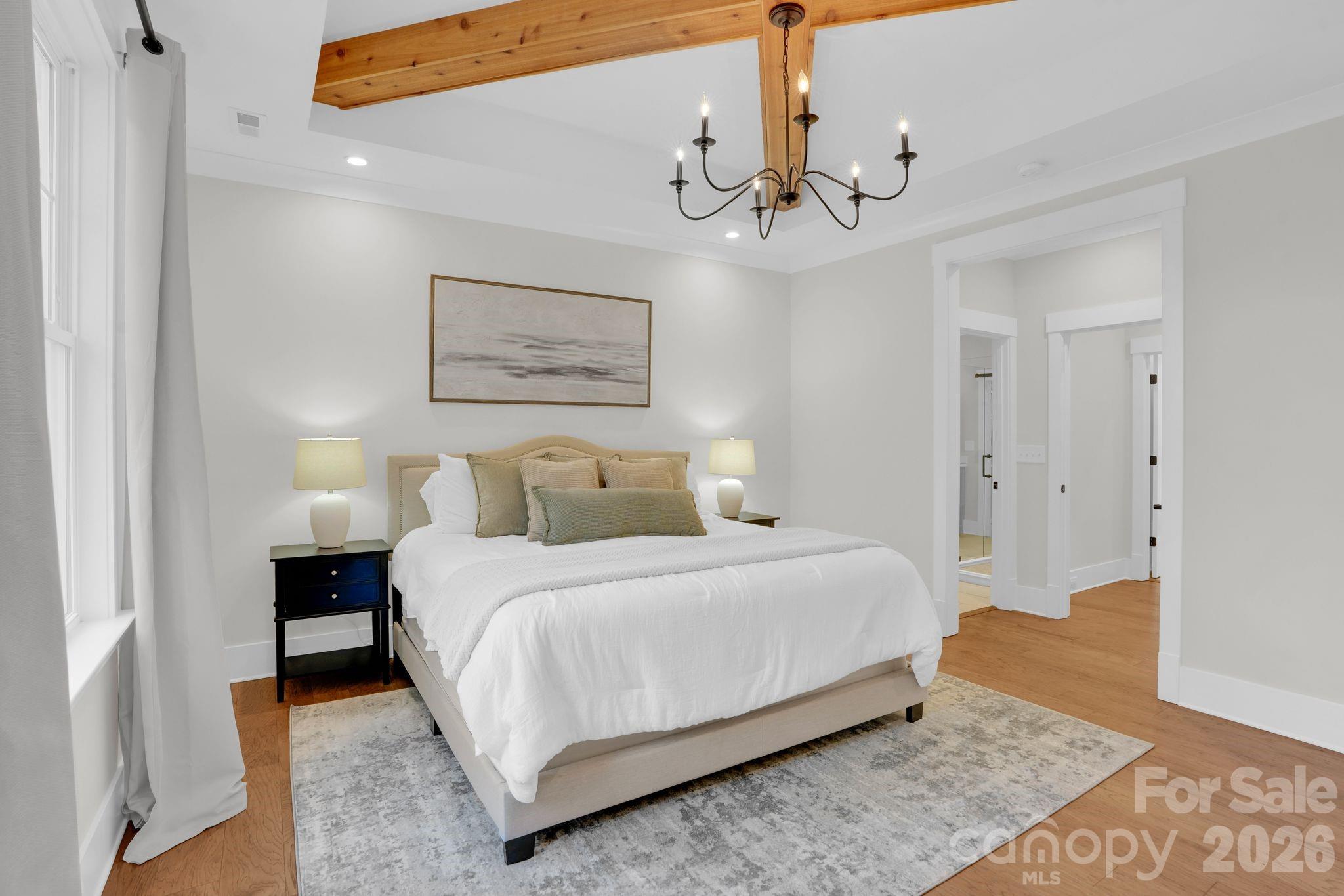 3134 Ranger Road Clover, SC 29710 - Photo 15 of 29 a bedroom with a large bed and a chandelier