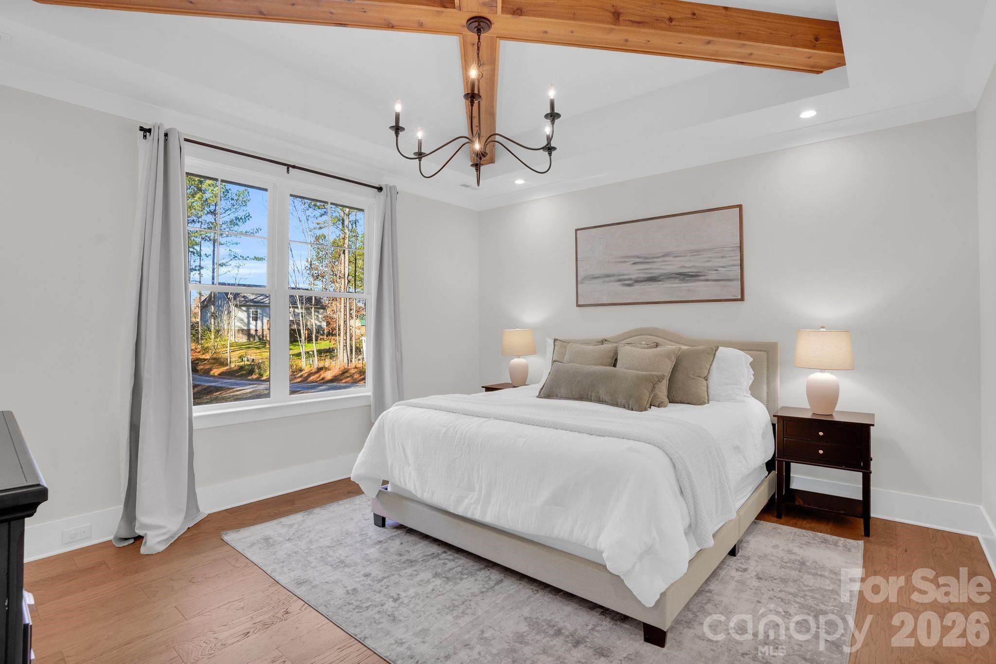 3134 Ranger Road Clover, SC 29710 - Photo 16 of 29 a bedroom with a large bed chandelier and a window