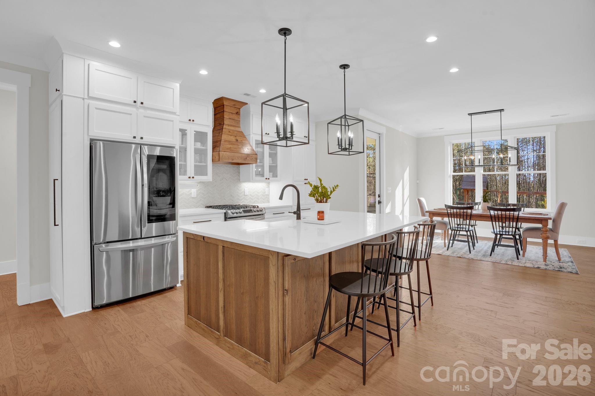 3134 Ranger Road Clover, SC 29710 - Photo 8 of 29 a open kitchen with stainless steel appliances granite countertop a kitchen island a stove and a dining table with kitchen view