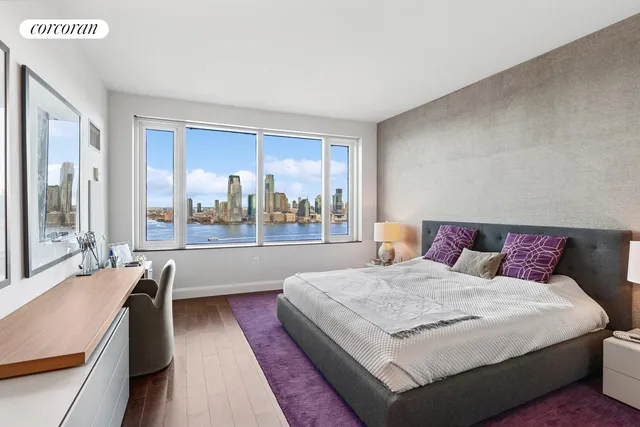 a bedroom with a large bed and a large window