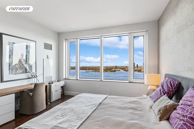 a bedroom with a large bed and a large window