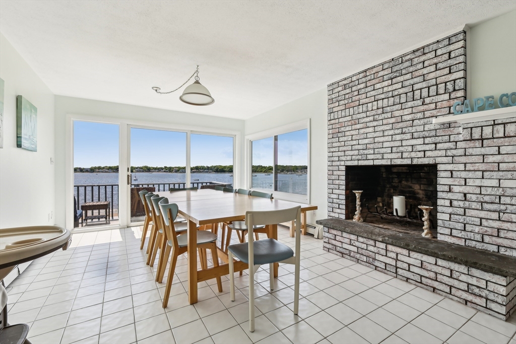57 Oak Street Wareham, MA 02571 - Photo 11 of 42 a dining room with furniture a fireplace and wooden floor