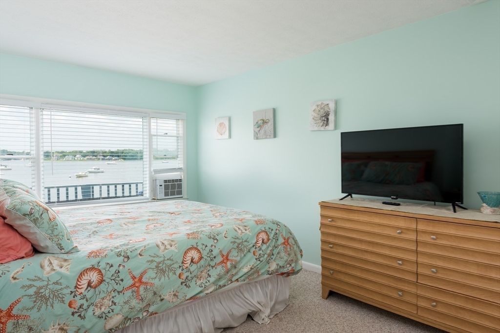 57 Oak Street Wareham, MA 02571 - Photo 13 of 42 a bedroom with a bed and a flat screen tv
