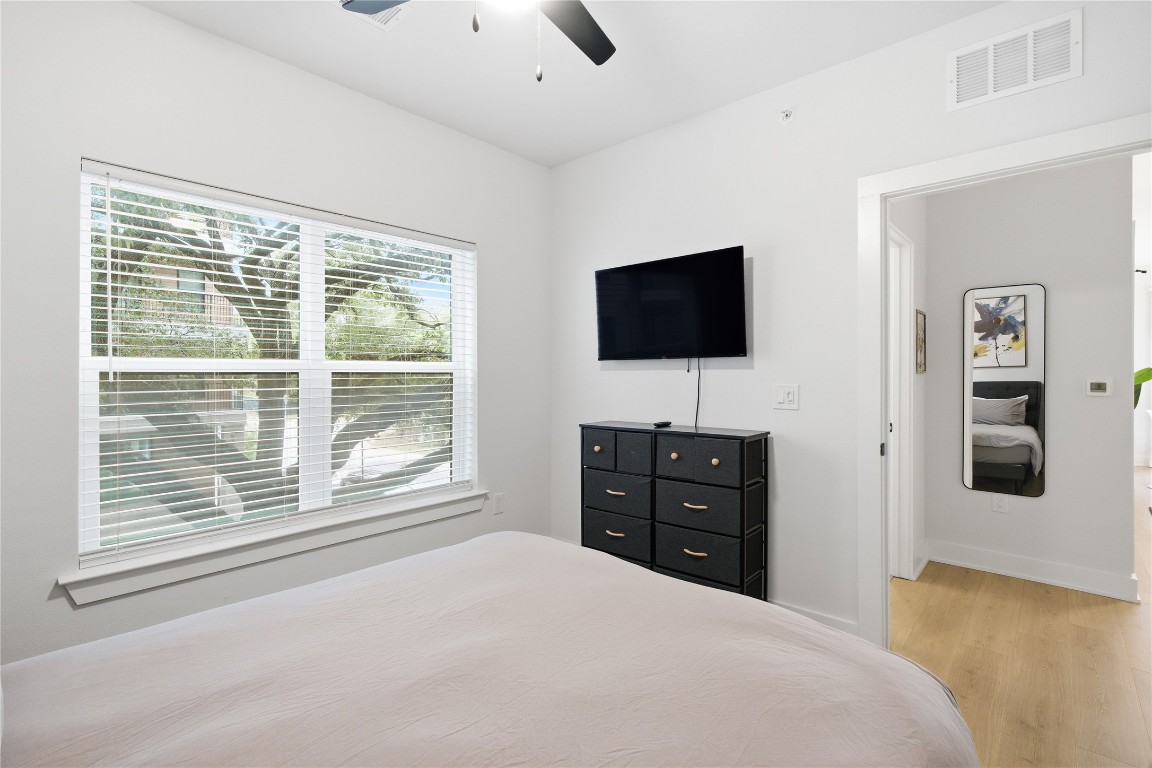 2500 Longview Street, Unit 201 Austin, TX 78705 - Photo 12 of 40 a bedroom with a bed and a flat screen tv
