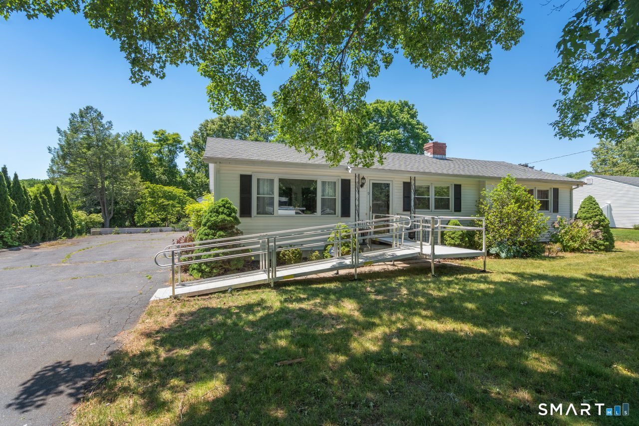 9 Stanton Road North Haven, CT 06473 - Photo 35 of 35 a front view of a house with a yard table and chairs