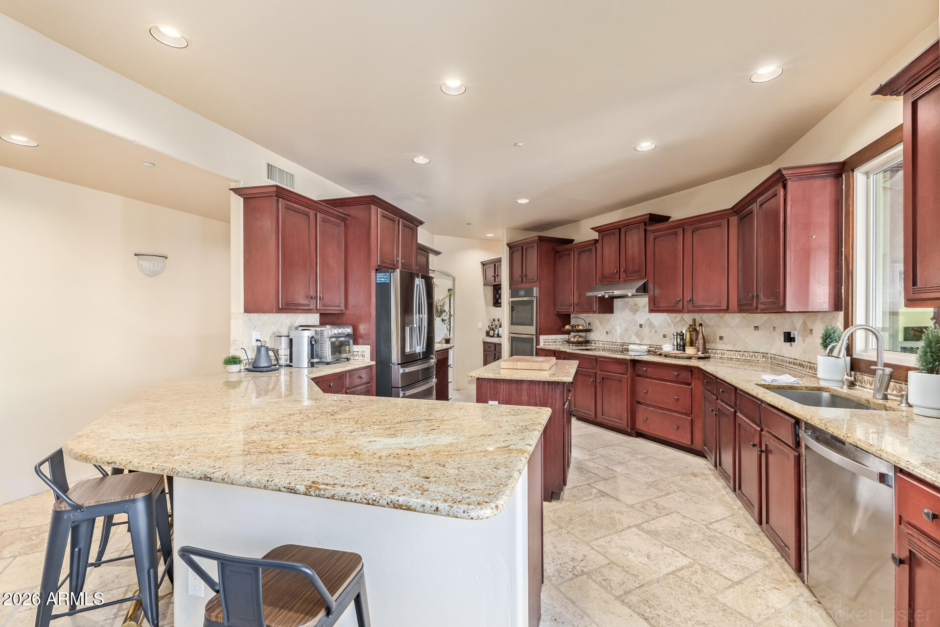 8549 East Bronco Trail Scottsdale, AZ 85255 - Photo 19 of 67 a kitchen with stainless steel appliances granite countertop a table chairs sink refrigerator and cabinets