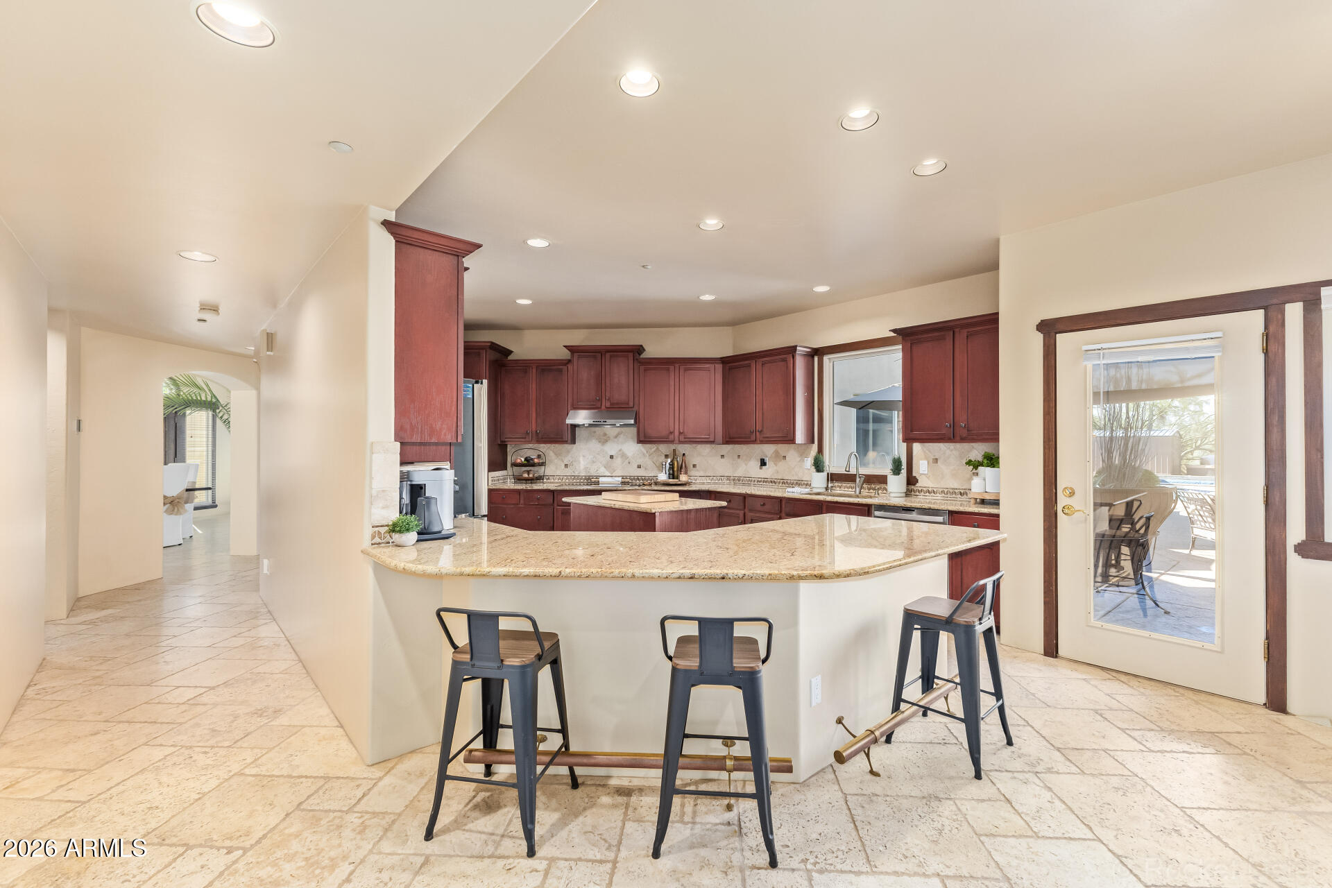 8549 East Bronco Trail Scottsdale, AZ 85255 - Photo 20 of 67 a kitchen with stainless steel appliances kitchen island granite countertop a table and chairs