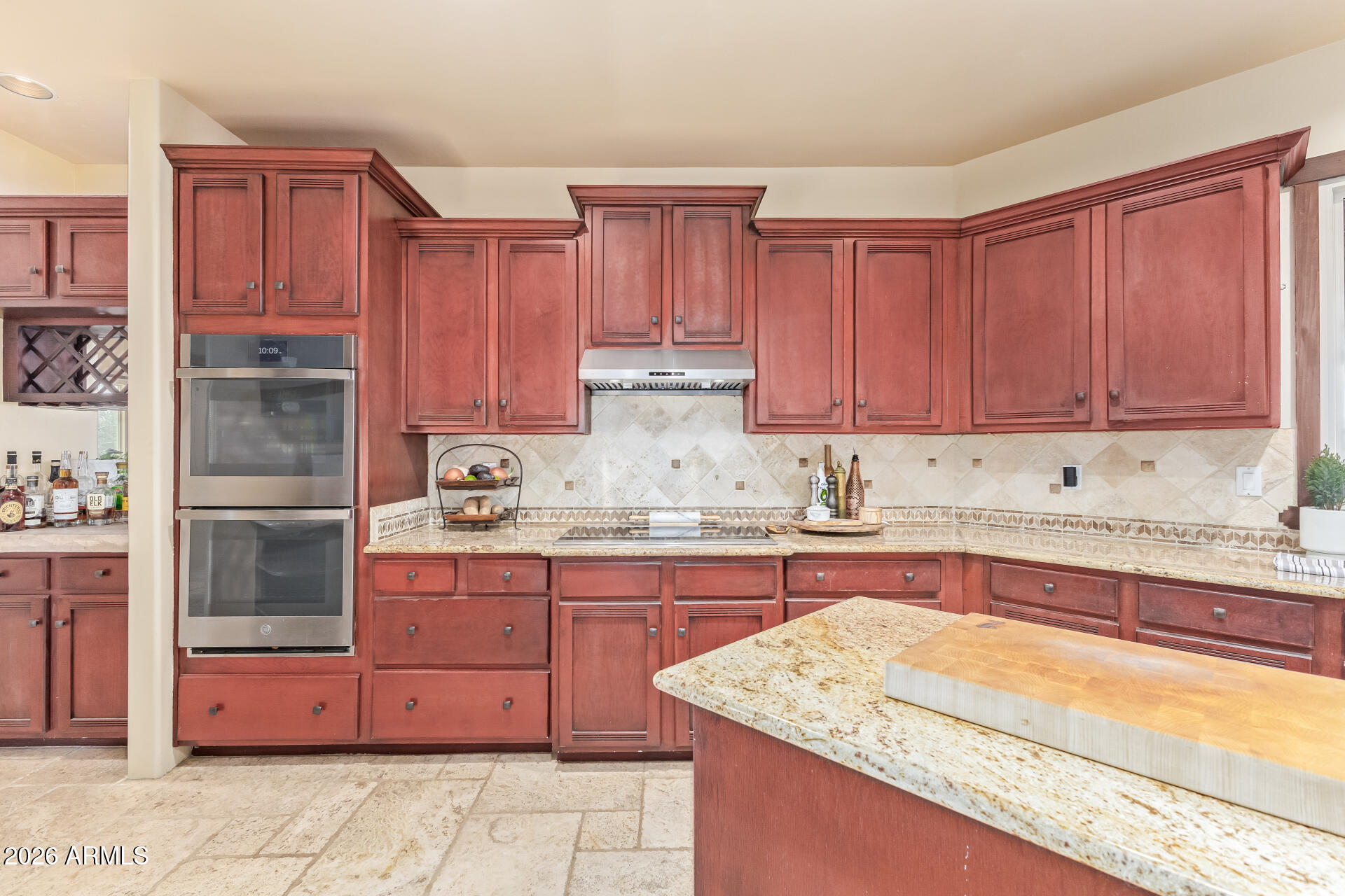 8549 East Bronco Trail Scottsdale, AZ 85255 - Photo 24 of 67 a kitchen with granite countertop a sink stove and cabinets