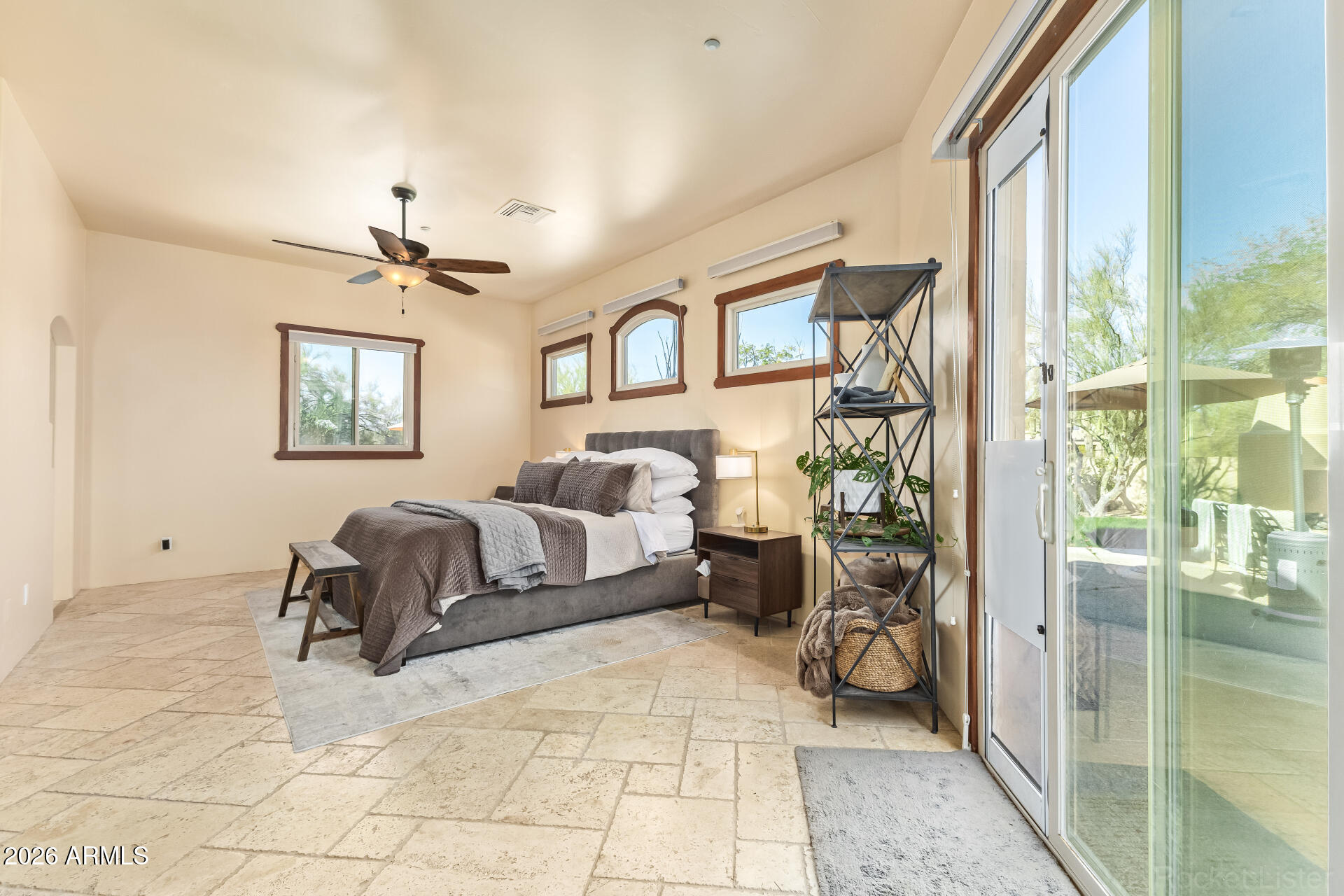 8549 East Bronco Trail Scottsdale, AZ 85255 - Photo 28 of 67 a spacious bedroom with a bed and a chandelier