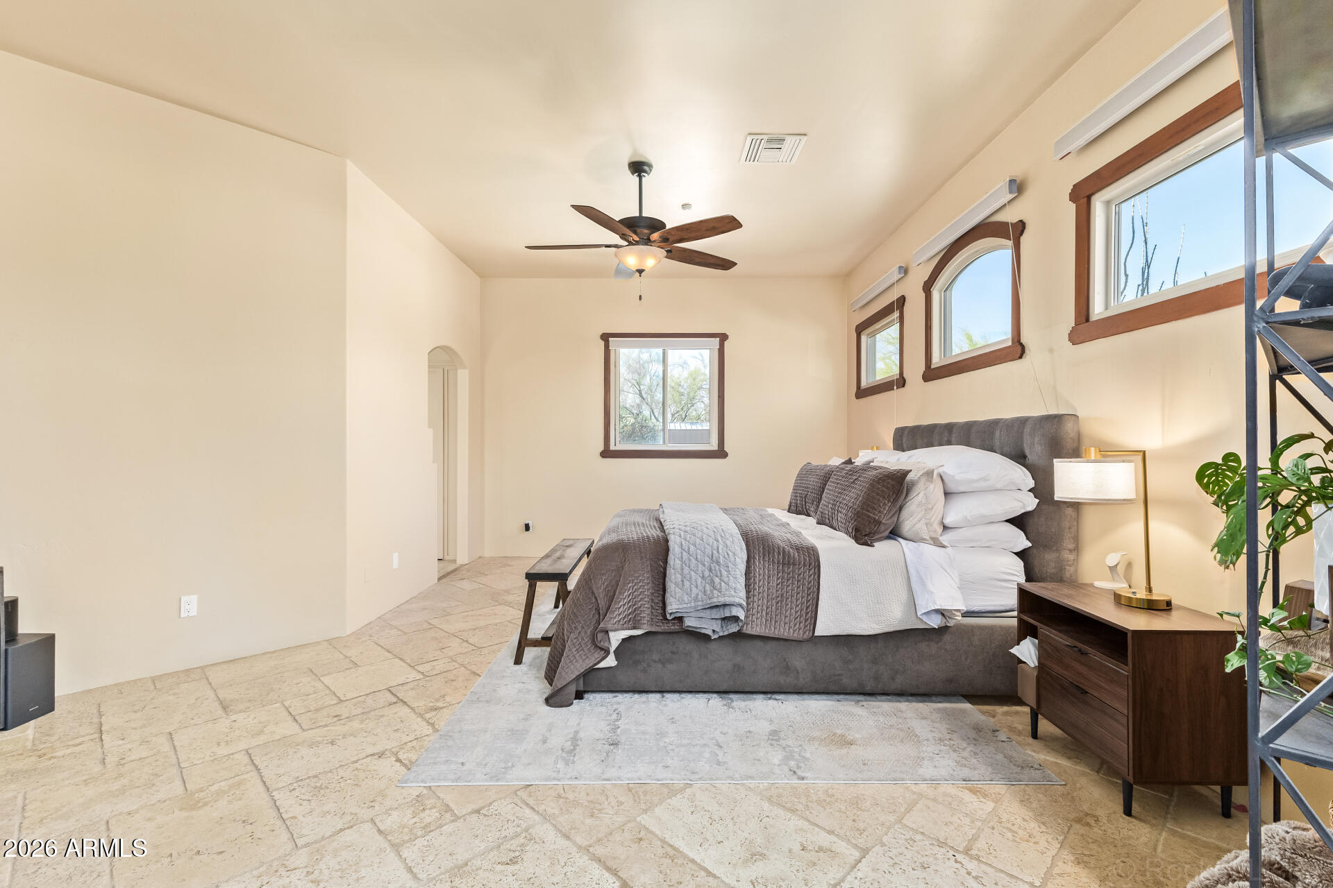 8549 East Bronco Trail Scottsdale, AZ 85255 - Photo 29 of 67 a spacious bedroom with a bed and a chandelier
