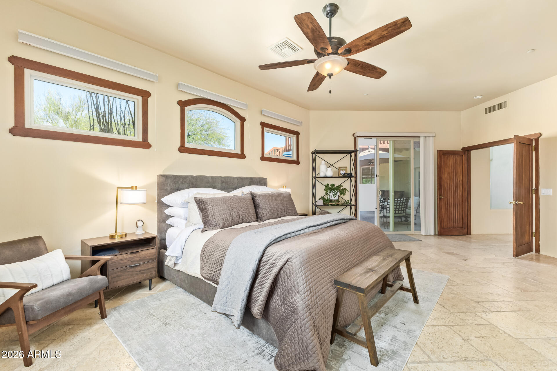 8549 East Bronco Trail Scottsdale, AZ 85255 - Photo 30 of 67 a spacious bedroom with a bed and glass walk in closet