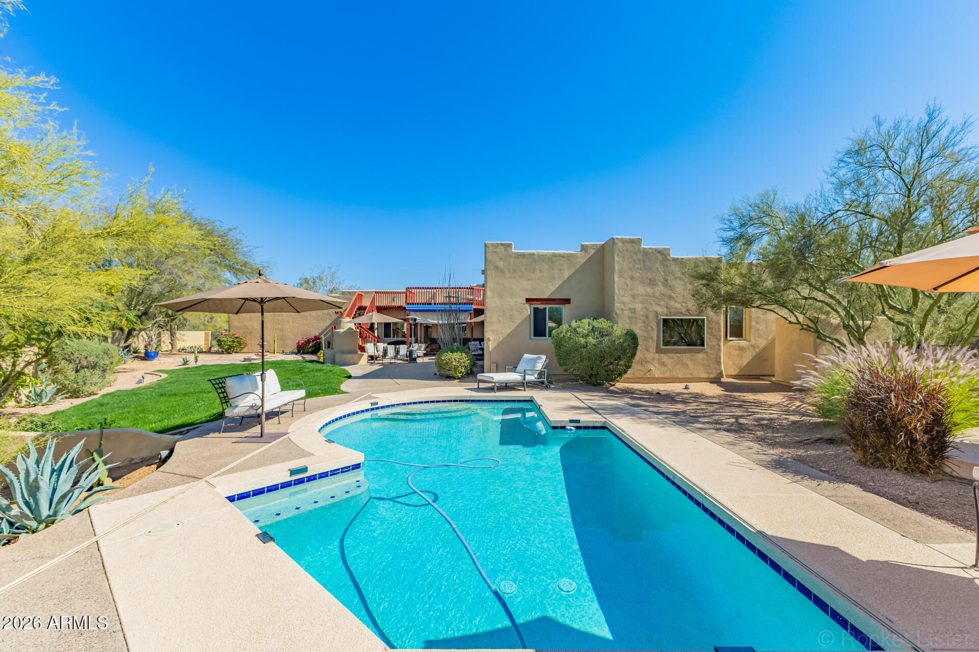 8549 East Bronco Trail Scottsdale, AZ 85255 - Photo 62 of 67 a view of a swimming pool with a patio