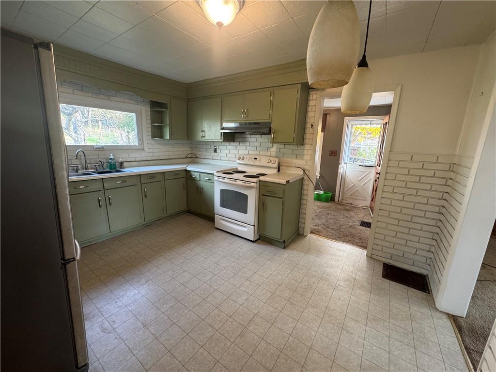 327 Rocktown Road Tarrs, PA 15688 - Photo 11 of 39 a kitchen with stainless steel appliances granite countertop a stove a sink and a refrigerator