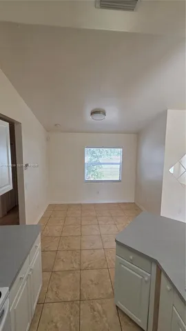 a view of an empty room and wooden floor