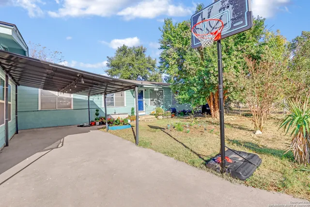 a view of a patio with a table and chairs under an umbrella