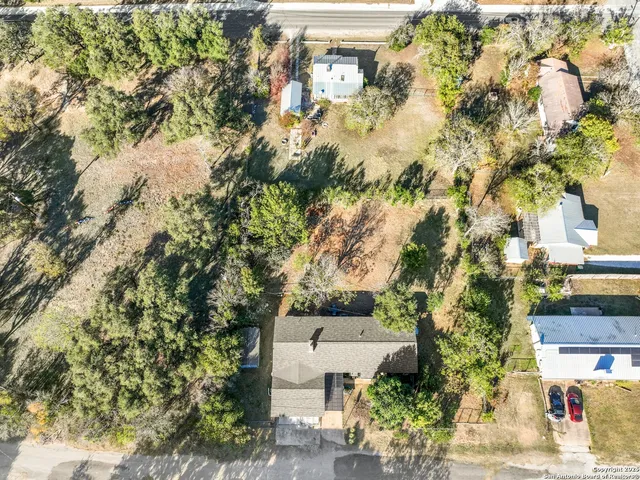 an aerial view of a house with a yard basket ball court and outdoor seating