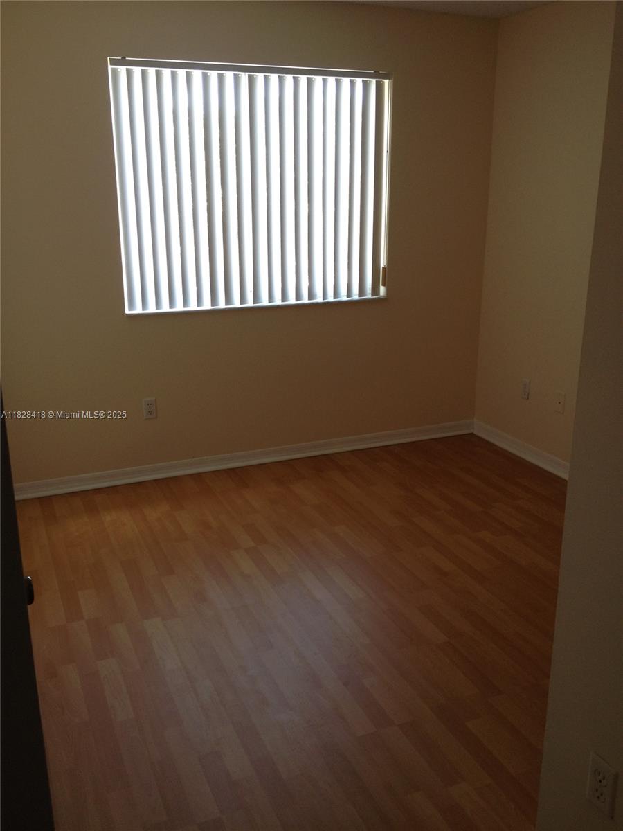 470 South Park Road, Unit 7308 Hollywood, FL 33021 - Photo 11 of 20 an empty room with wooden floor and windows