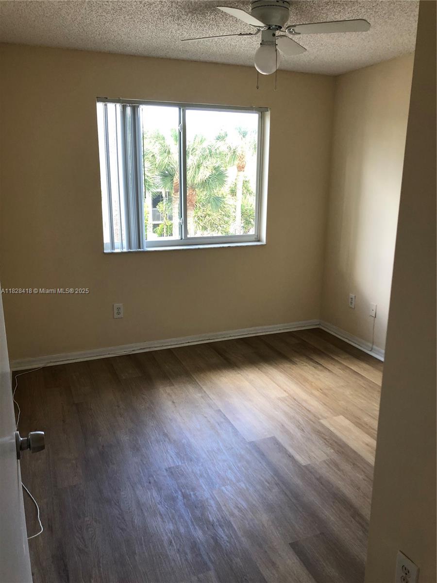 470 South Park Road, Unit 7308 Hollywood, FL 33021 - Photo 13 of 20 an empty room with wooden floor and windows