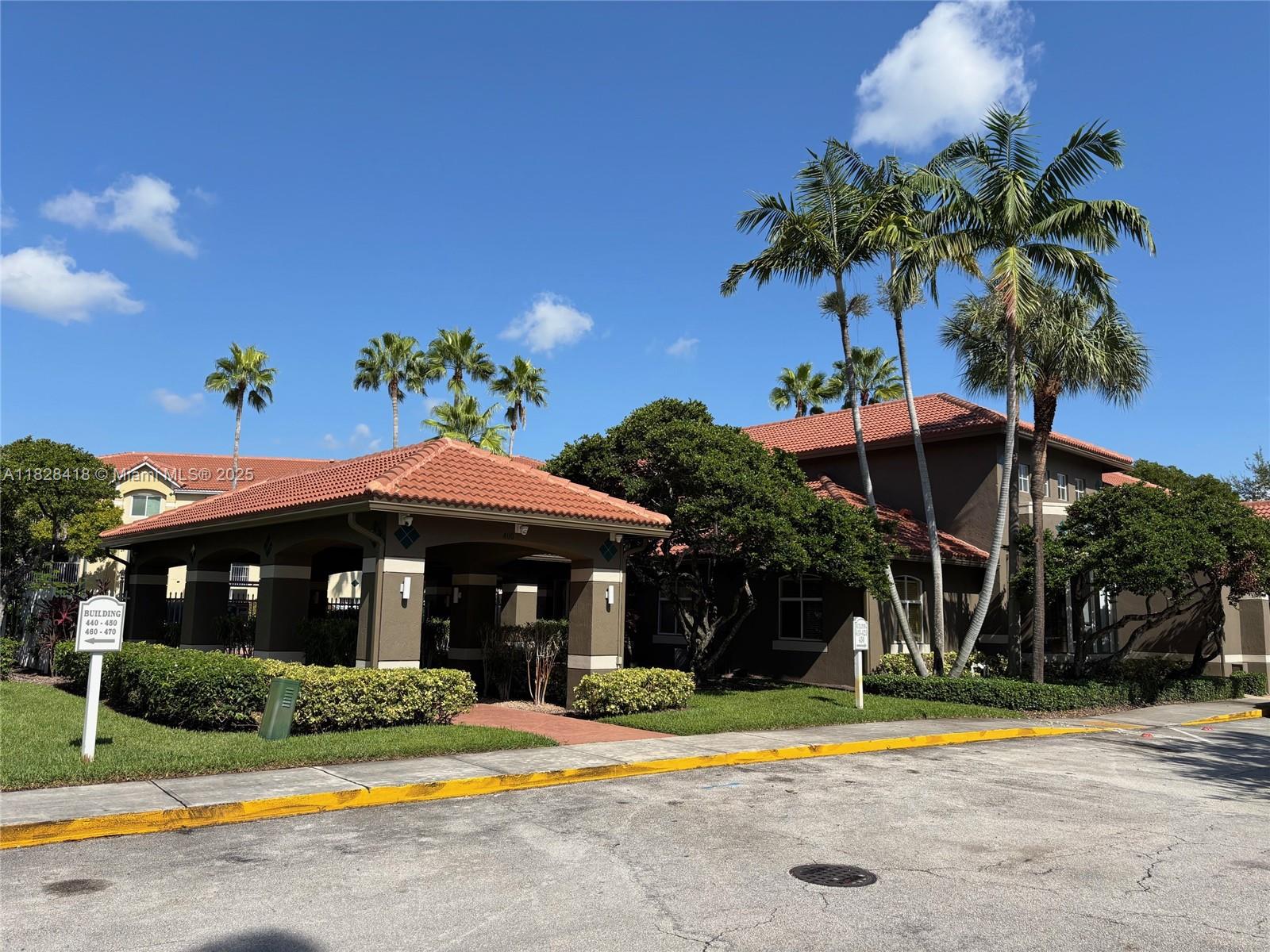 470 South Park Road, Unit 7308 Hollywood, FL 33021 - Photo 15 of 20 a front view of a house with a yard and potted plants