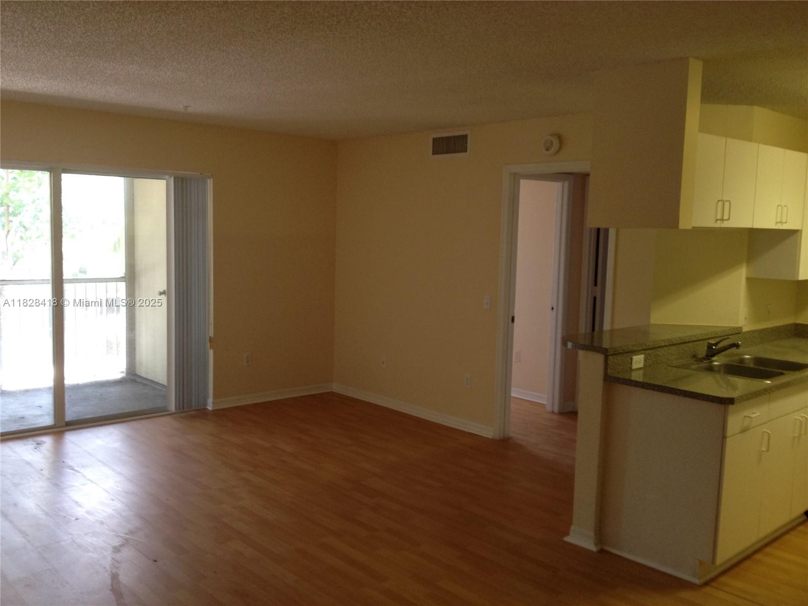 470 South Park Road, Unit 7308 Hollywood, FL 33021 - Photo 6 of 20 a view of a kitchen with wooden floor and a window