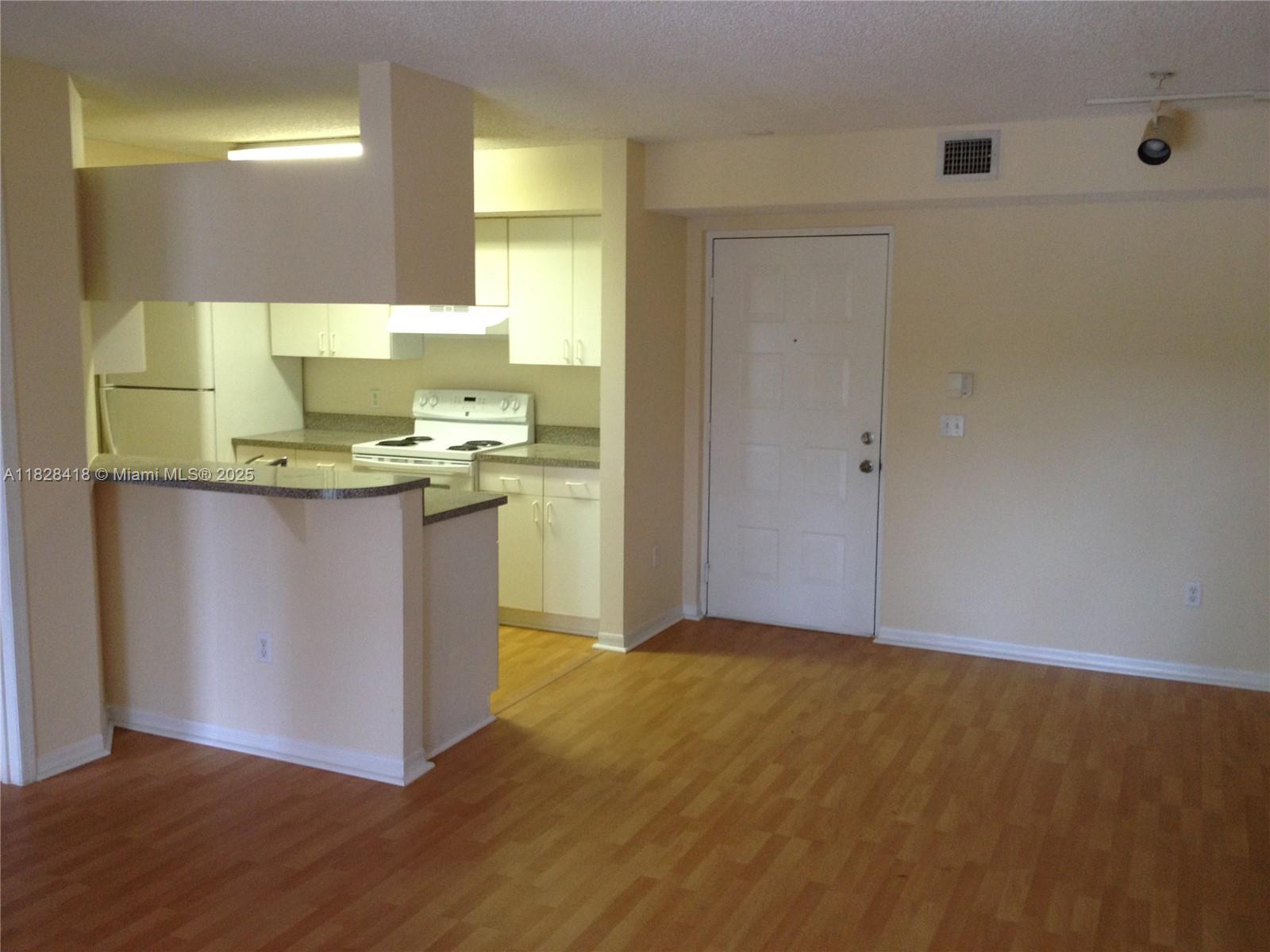 470 South Park Road, Unit 7308 Hollywood, FL 33021 - Photo 7 of 20 a kitchen with stainless steel appliances granite countertop a sink a stove a counter space and cabinets
