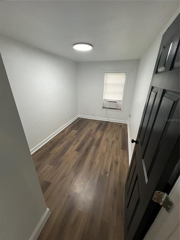 5195 Countryside Court St. Cloud, FL 34771 - Photo 11 of 20 an empty room with wooden floor and windows