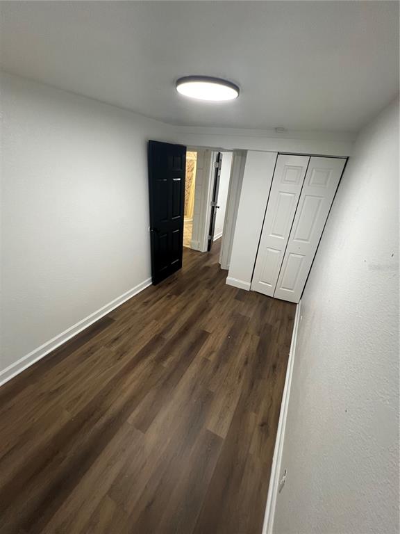 5195 Countryside Court St. Cloud, FL 34771 - Photo 12 of 20 wooden floor in an empty room with a window