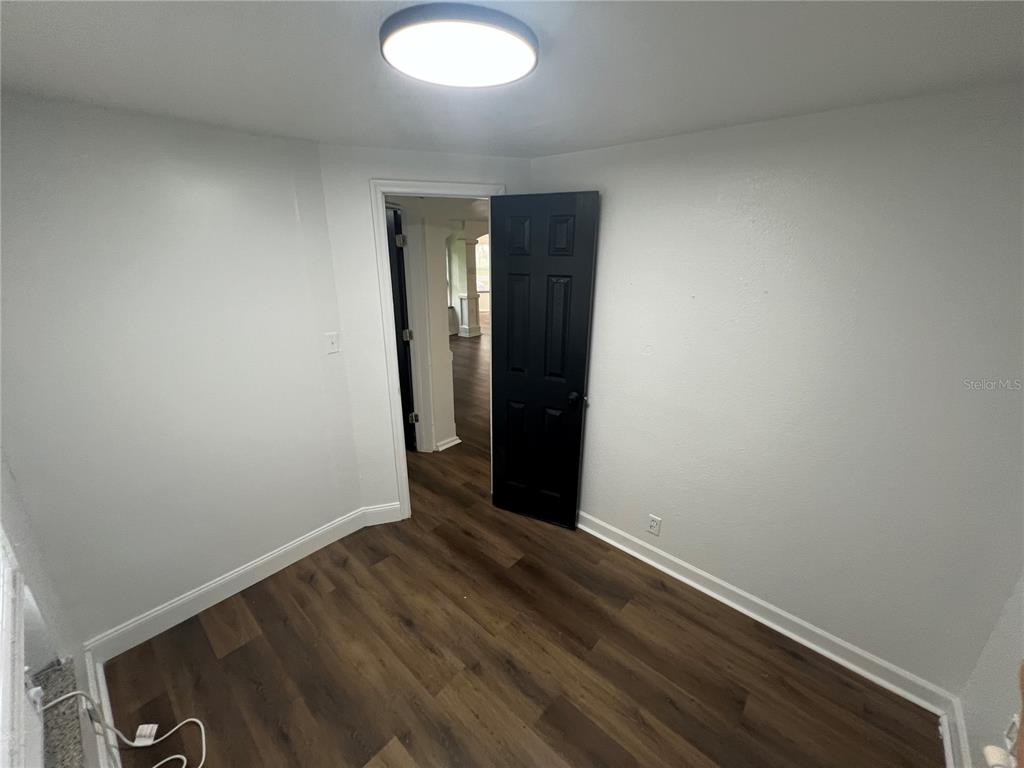 5195 Countryside Court St. Cloud, FL 34771 - Photo 15 of 20 a view of an empty room with wooden floor