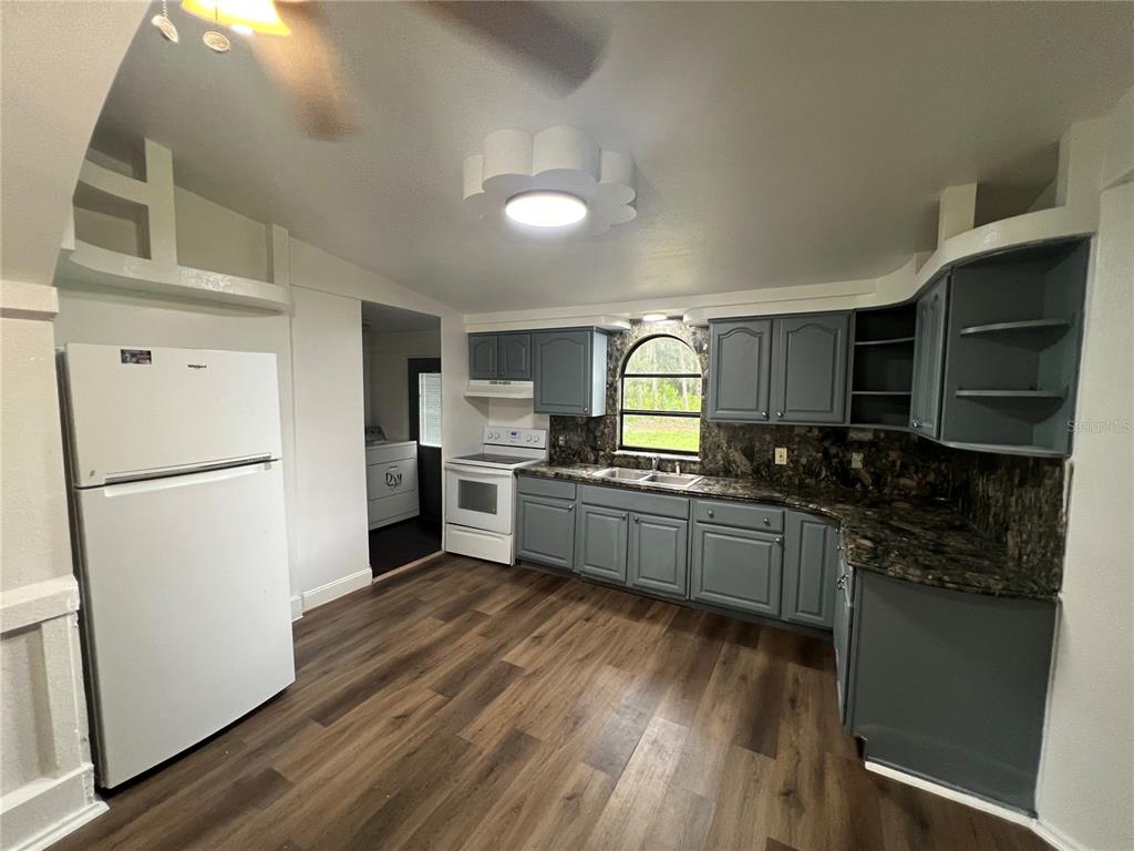 5195 Countryside Court St. Cloud, FL 34771 - Photo 17 of 20 a kitchen with stainless steel appliances a refrigerator a stove top oven and sink