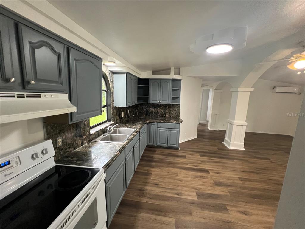 5195 Countryside Court St. Cloud, FL 34771 - Photo 18 of 20 a large kitchen with stainless steel appliances granite countertop a stove a sink and a granite counter tops