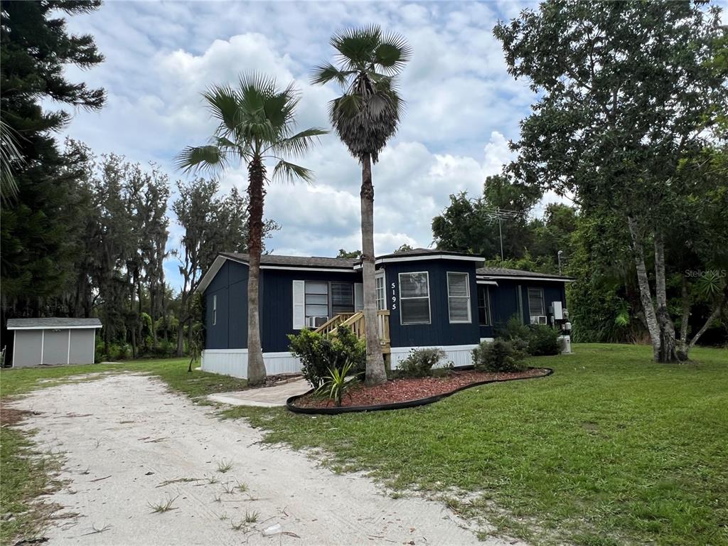 5195 Countryside Court St. Cloud, FL 34771 - Photo 2 of 20 a view of a house with backyard and sitting area