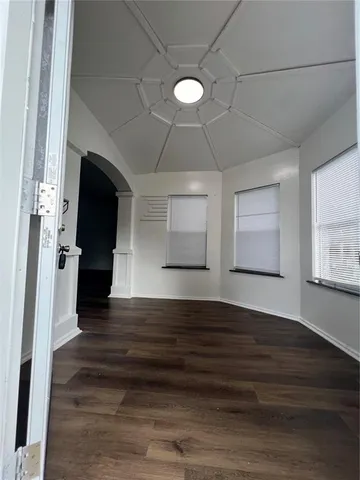 a view of entryway and hall with wooden floor