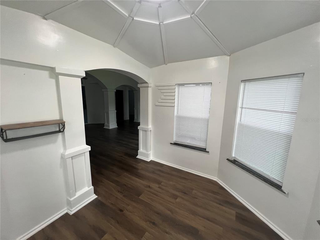 5195 Countryside Court St. Cloud, FL 34771 - Photo 4 of 20 wooden floor in an empty room with a window