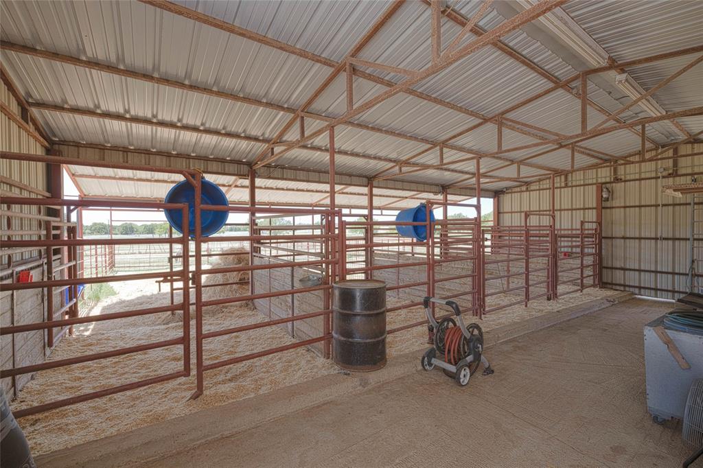 151 County Road 3699 Springtown, TX 76082 - Photo 31 of 35 Spacious covered livestock pen with a metal roof and corrugated metal siding