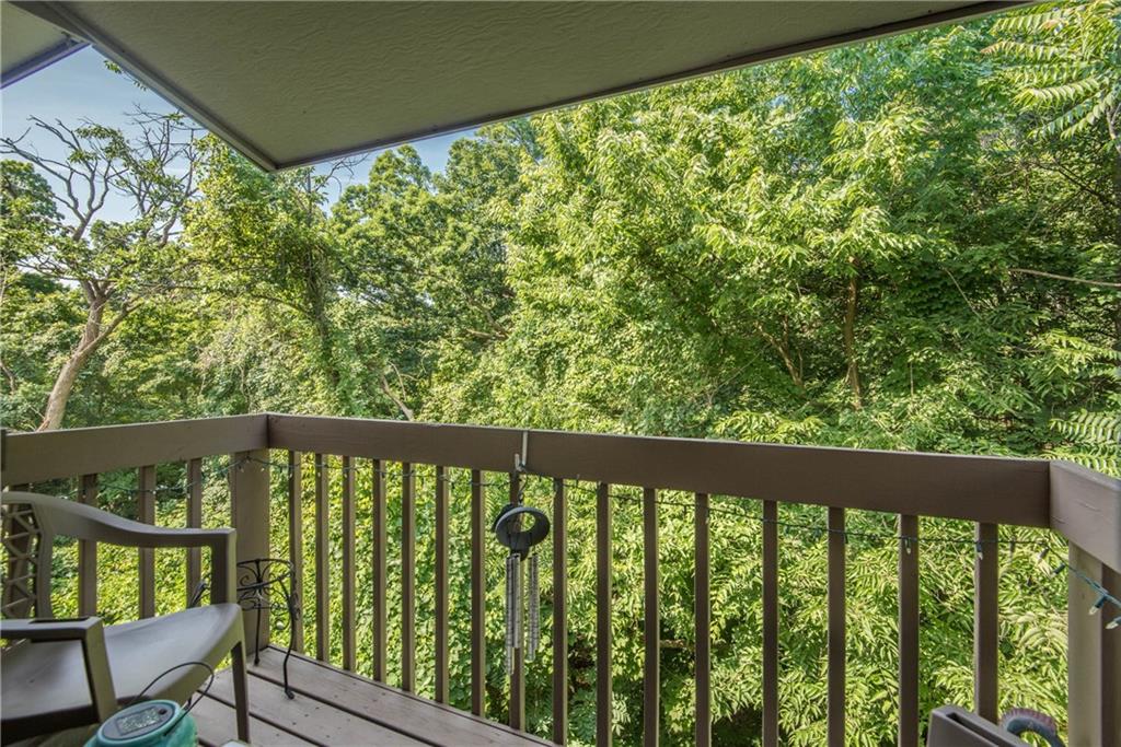 329 Ridge Point Circle, Unit 34B Bridgeville, PA 15017 - Photo 19 of 25 Just off the living space, a private deck faces a wooded area.