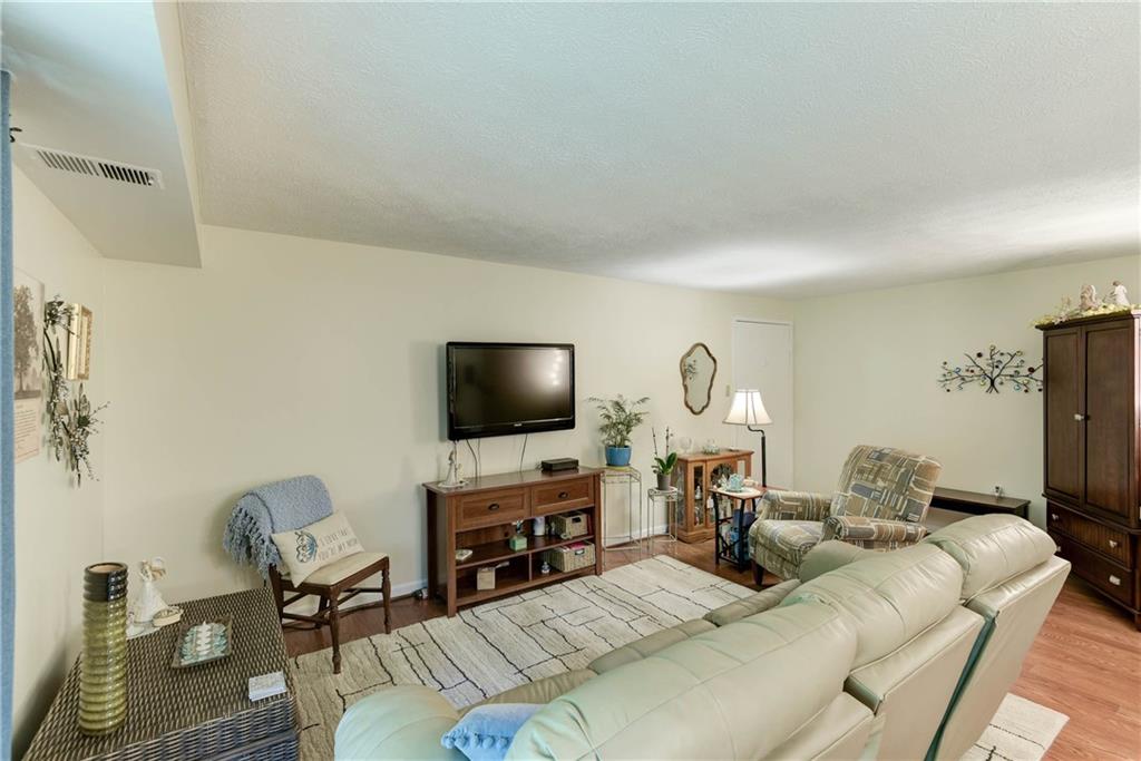 329 Ridge Point Circle, Unit 34B Bridgeville, PA 15017 - Photo 5 of 25 Light laminate hardwood floors and tasteful neutral tones flow throughout the home.