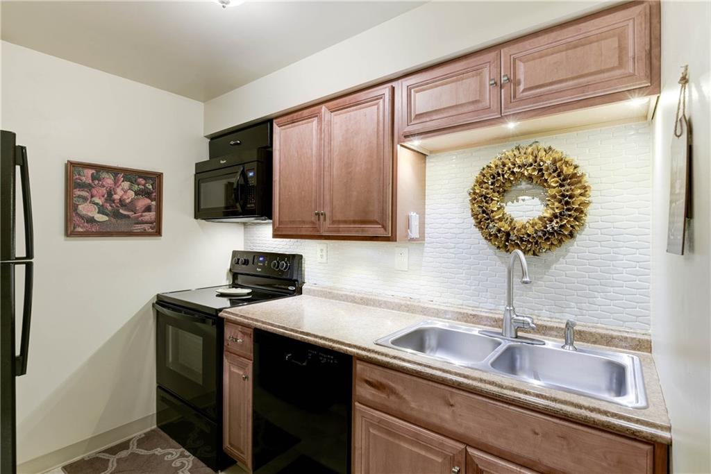 329 Ridge Point Circle, Unit 34B Bridgeville, PA 15017 - Photo 9 of 25 The updated kitchen features nice counters and cabinets, newer appliances, and a cool, contemporary back-splash.