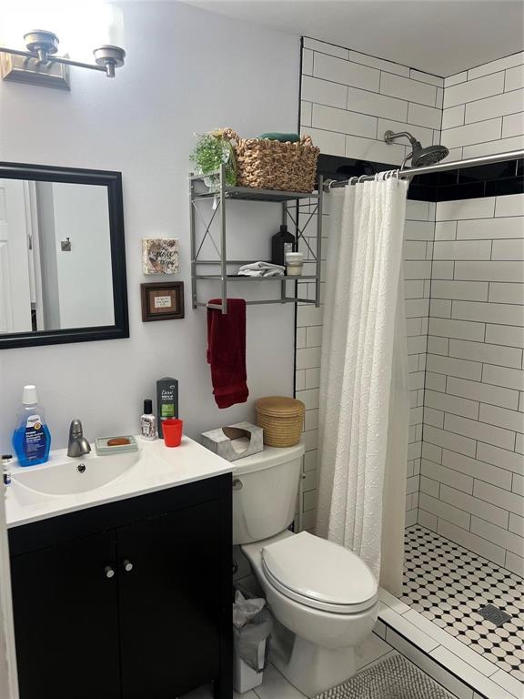 2211 Muret Street Irving, TX 75062 - Photo 11 of 16 a bathroom with a sink toilet and shower