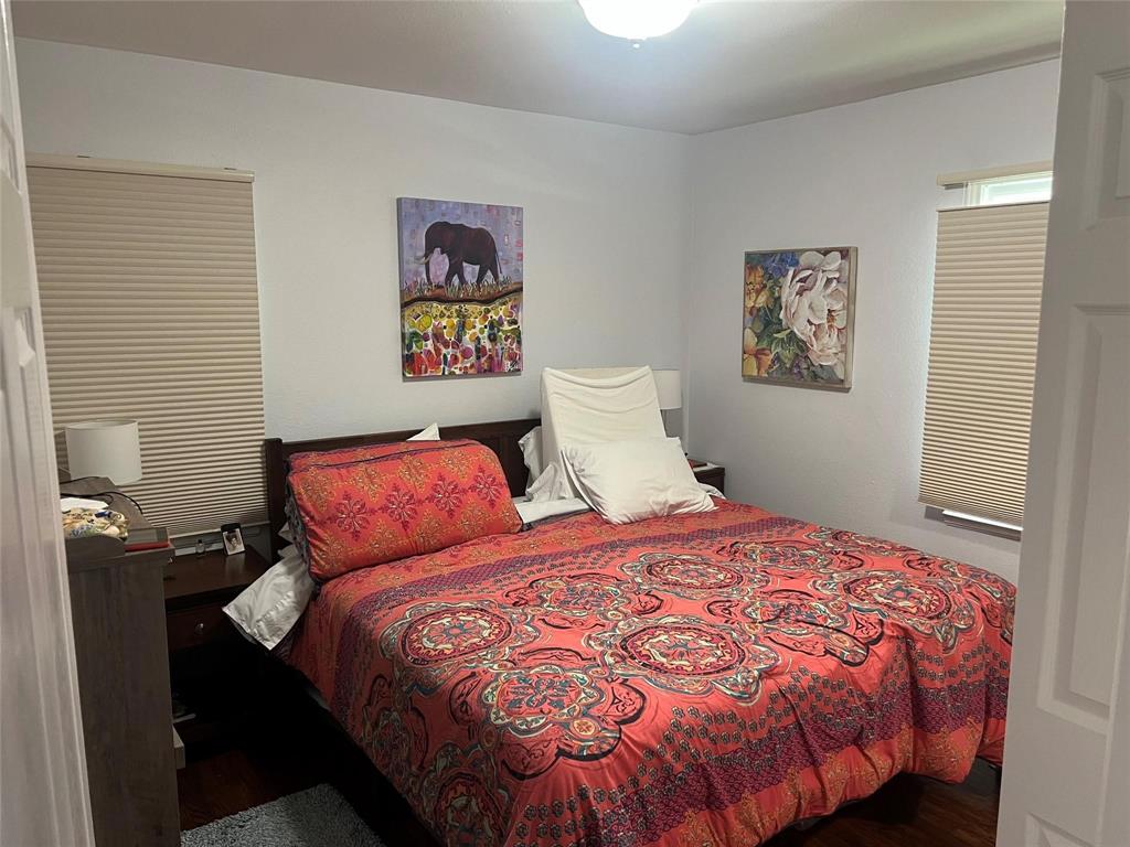 2211 Muret Street Irving, TX 75062 - Photo 12 of 16 a bedroom with a bed and painting on the wall