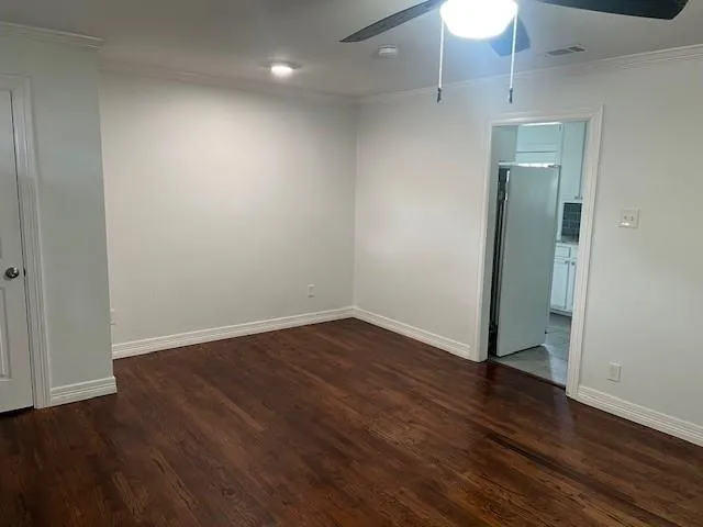 an empty room with wooden floor and closet