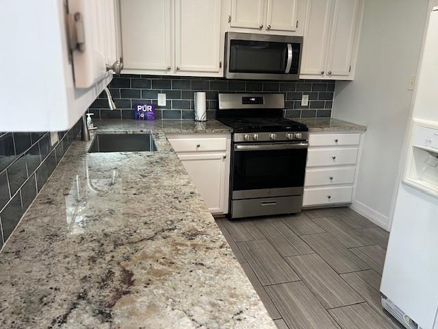 2211 Muret Street Irving, TX 75062 - Photo 9 of 16 a kitchen with granite countertop a stove and a microwave