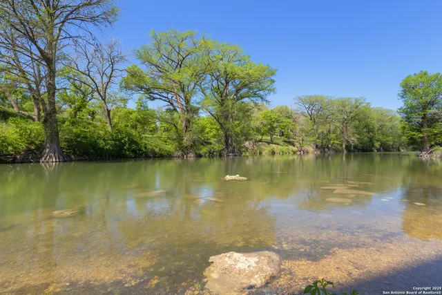 a view of a lake with a yard