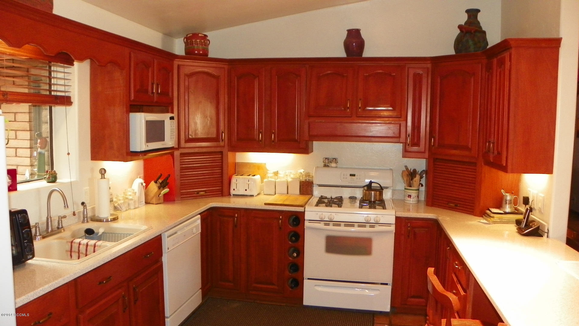 1623 Bufeo Court Rio Rico, AZ 85648 - Photo 16 of 52 a kitchen with stainless steel appliances a stove a sink and a microwave