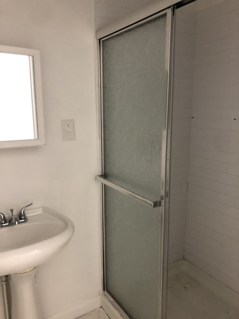2449 North Clybourn Avenue, Unit 1 Chicago, IL 60614 - Photo 7 of 10 a bathroom with a sink a toilet and a mirror