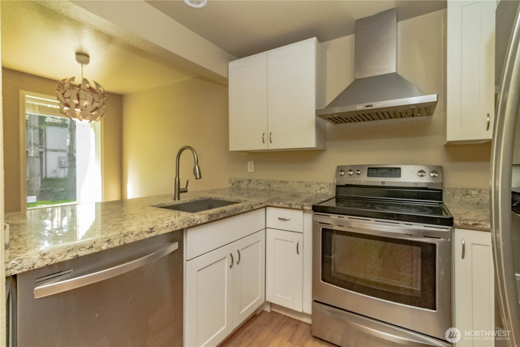 17425 119th Lane Southeast, Unit D12 Renton, WA 98058 - Photo 1 of 25 a kitchen with granite countertop a sink stove and cabinets