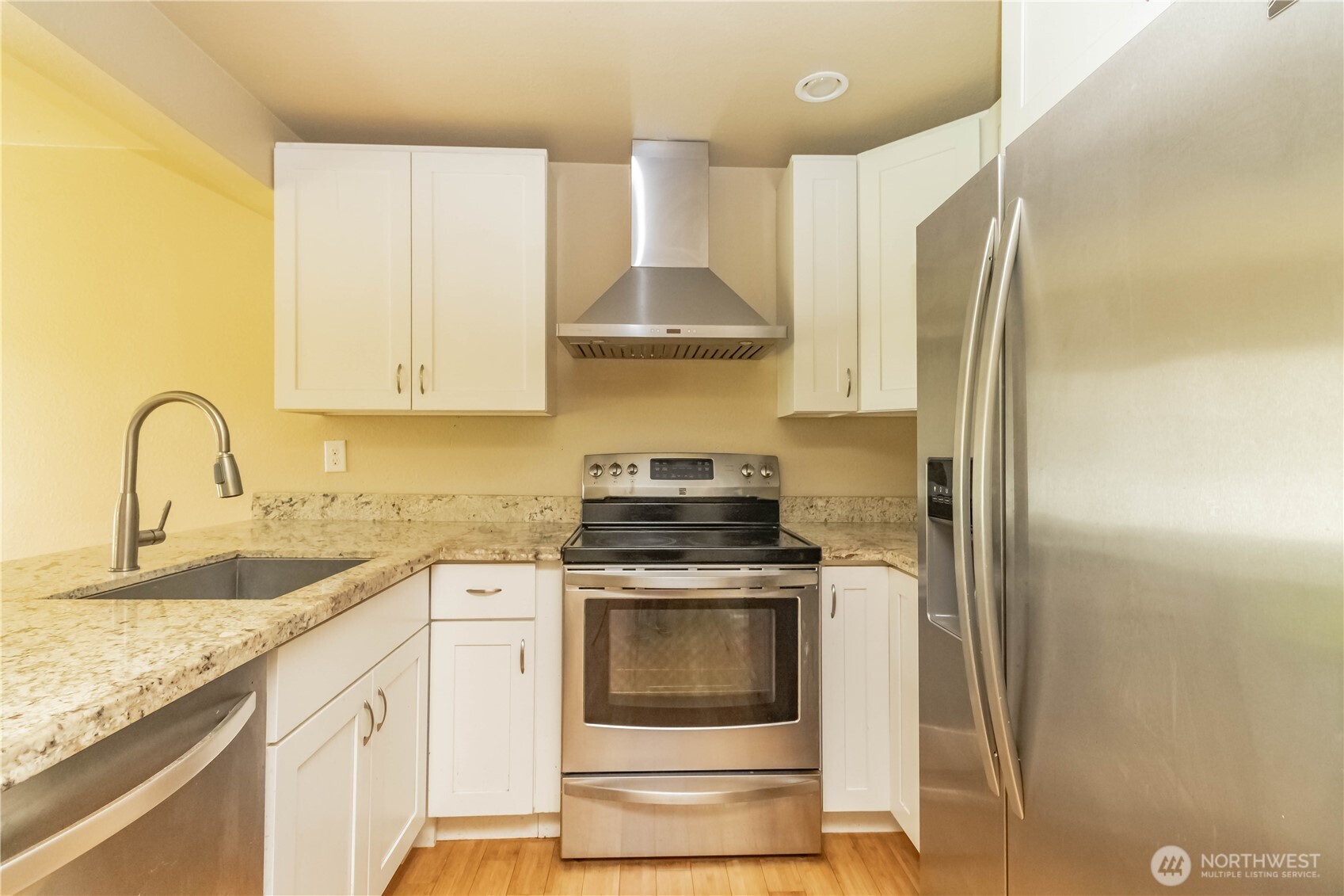 17425 119th Lane Southeast, Unit D12 Renton, WA 98058 - Photo 3 of 25 a kitchen with stainless steel appliances granite countertop a stove and a sink